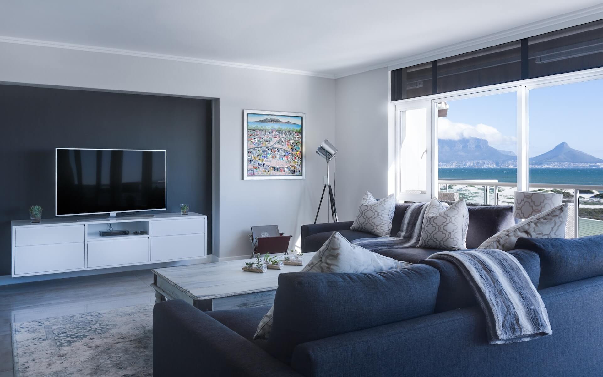 A minimalist, cool-toned neutral living room design.